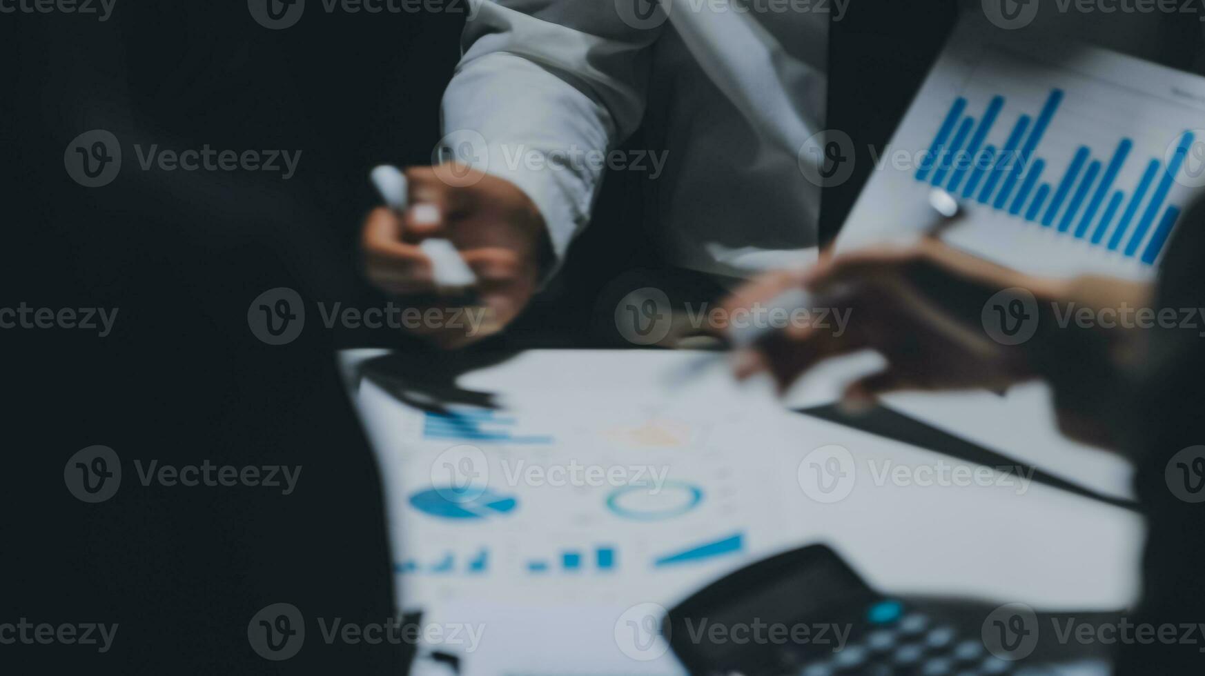Financial analysts analyze business financial reports on a digital tablet planning investment project during a discussion at a meeting of corporate showing the results of their successful teamwork. photo