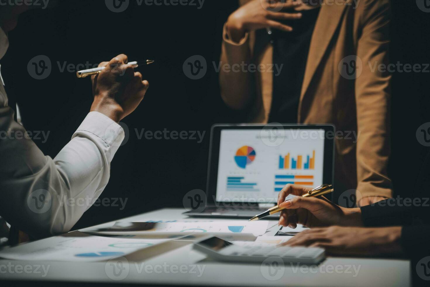 Financial analysts analyze business financial reports on a digital tablet planning investment project during a discussion at a meeting of corporate showing the results of their successful teamwork. photo