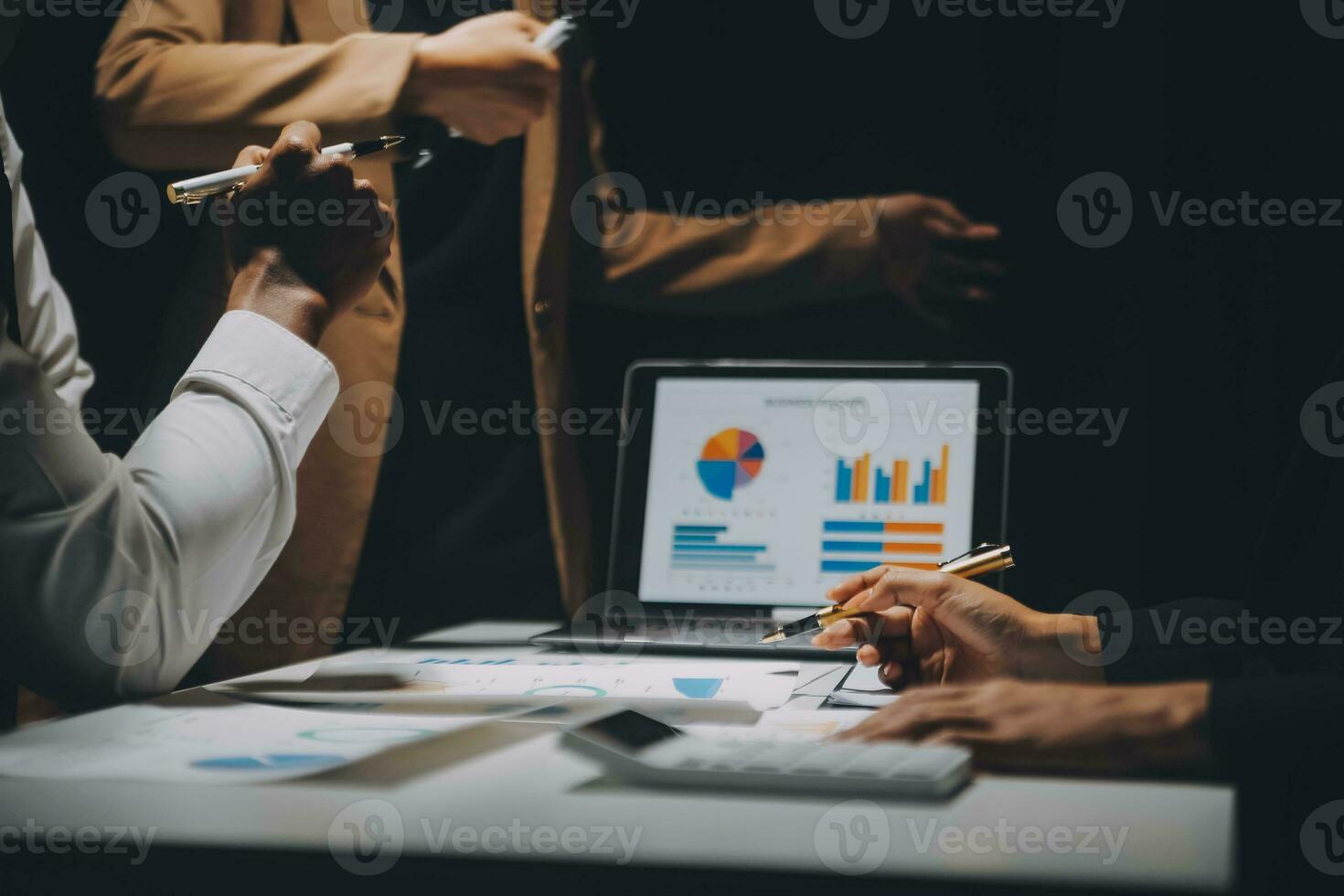 Financial analysts analyze business financial reports on a digital tablet planning investment project during a discussion at a meeting of corporate showing the results of their successful teamwork. photo