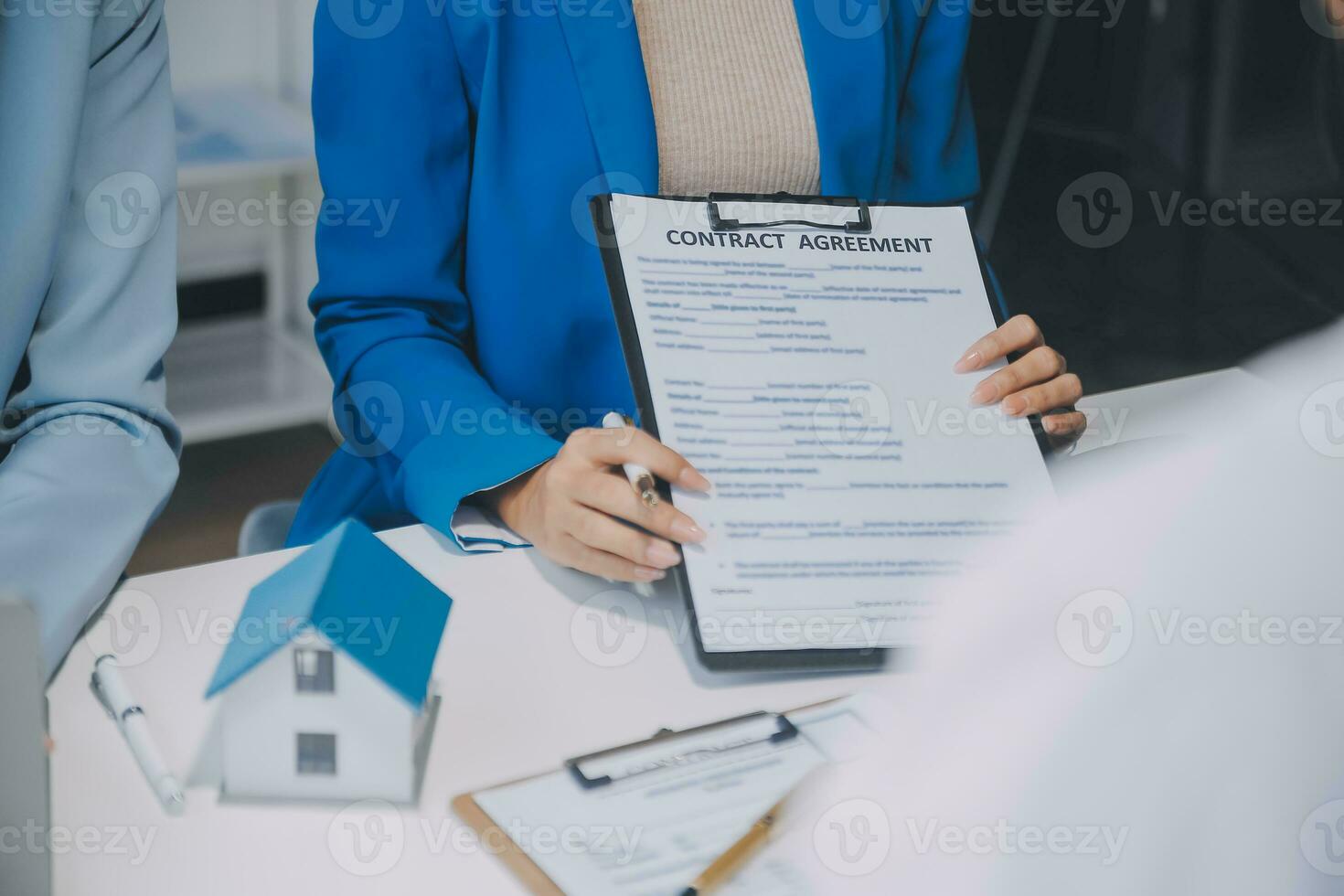 Real estate agent and customer signing contract to buy house, insurance or loan real estate.rent a house,get insurance or loan real estate or property. photo