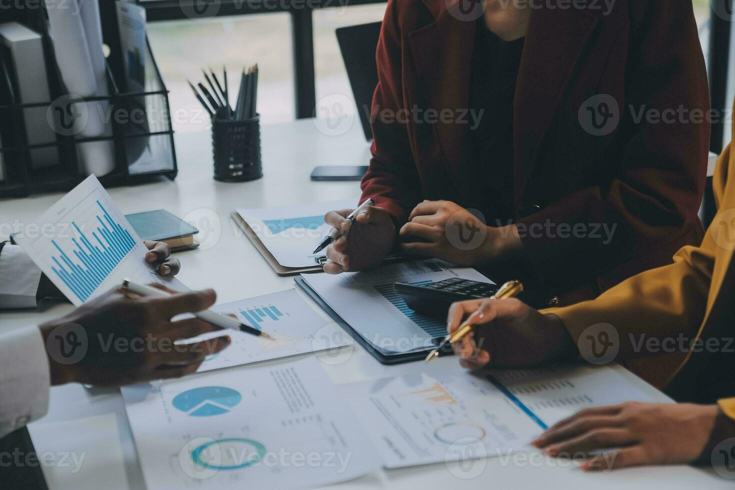 Financial analysts analyze business financial reports on a digital tablet planning investment project during a discussion at a meeting of corporate showing the results of their successful teamwork. photo