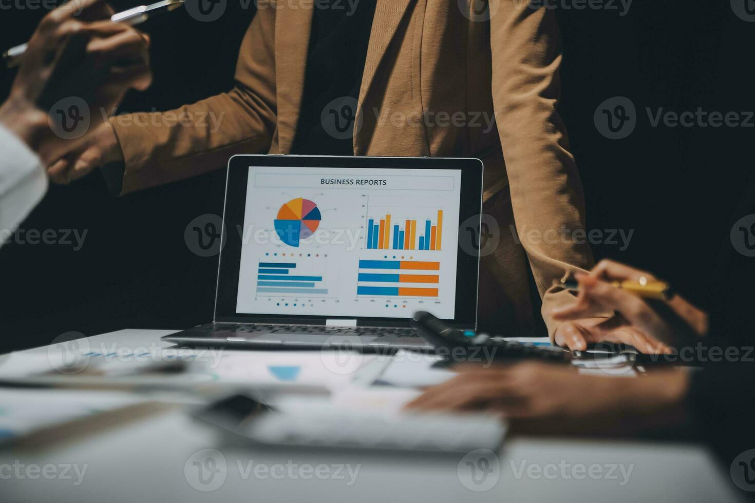 Financial analysts analyze business financial reports on a digital tablet planning investment project during a discussion at a meeting of corporate showing the results of their successful teamwork. photo