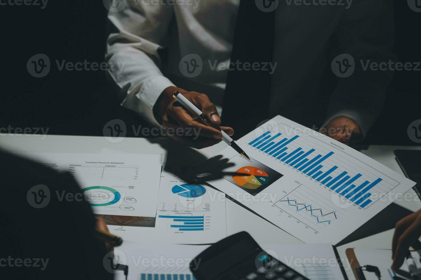 Financial analysts analyze business financial reports on a digital tablet planning investment project during a discussion at a meeting of corporate showing the results of their successful teamwork. photo