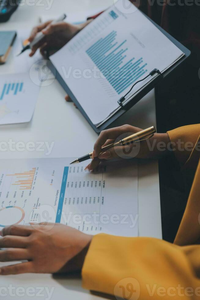 Financial analysts analyze business financial reports on a digital tablet planning investment project during a discussion at a meeting of corporate showing the results of their successful teamwork. photo