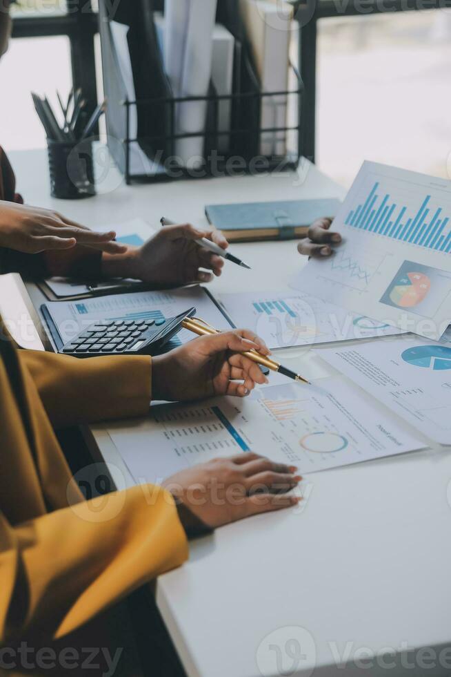 Financial analysts analyze business financial reports on a digital tablet planning investment project during a discussion at a meeting of corporate showing the results of their successful teamwork. photo