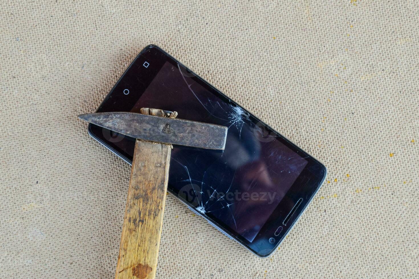 martillo y teléfono inteligente el pantalla de el teléfono inteligente, un roto decir ah foto