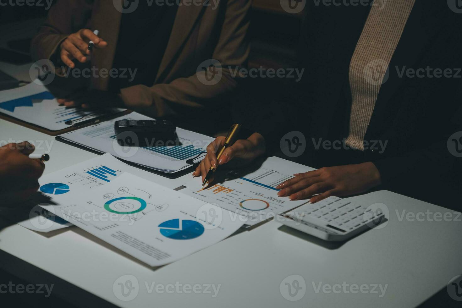 Financial analysts analyze business financial reports on a digital tablet planning investment project during a discussion at a meeting of corporate showing the results of their successful teamwork. photo