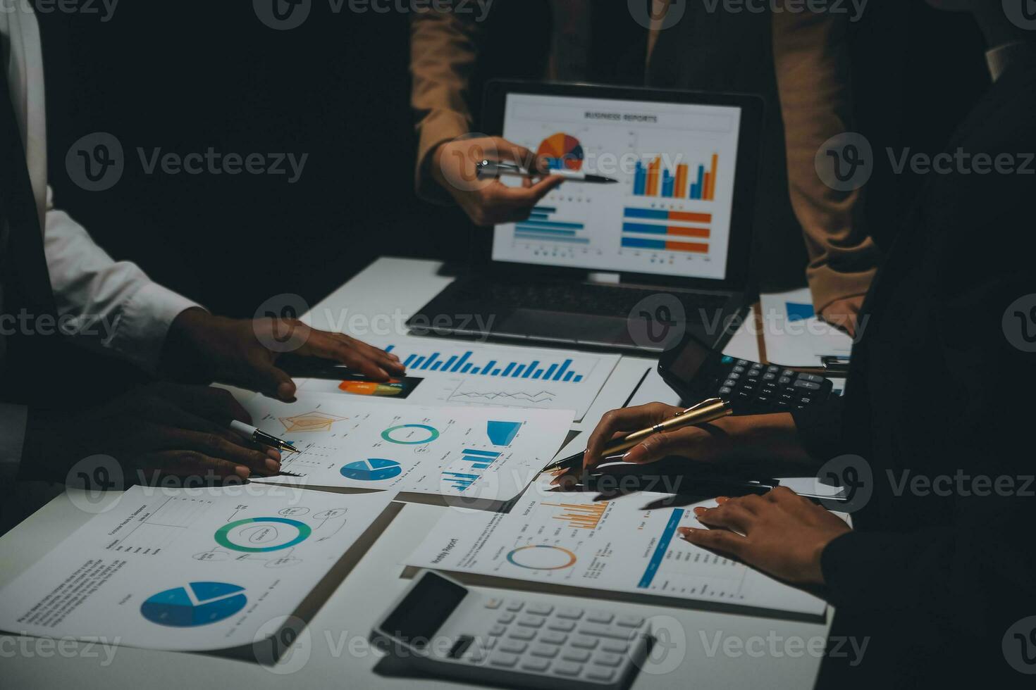 Financial analysts analyze business financial reports on a digital tablet planning investment project during a discussion at a meeting of corporate showing the results of their successful teamwork. photo