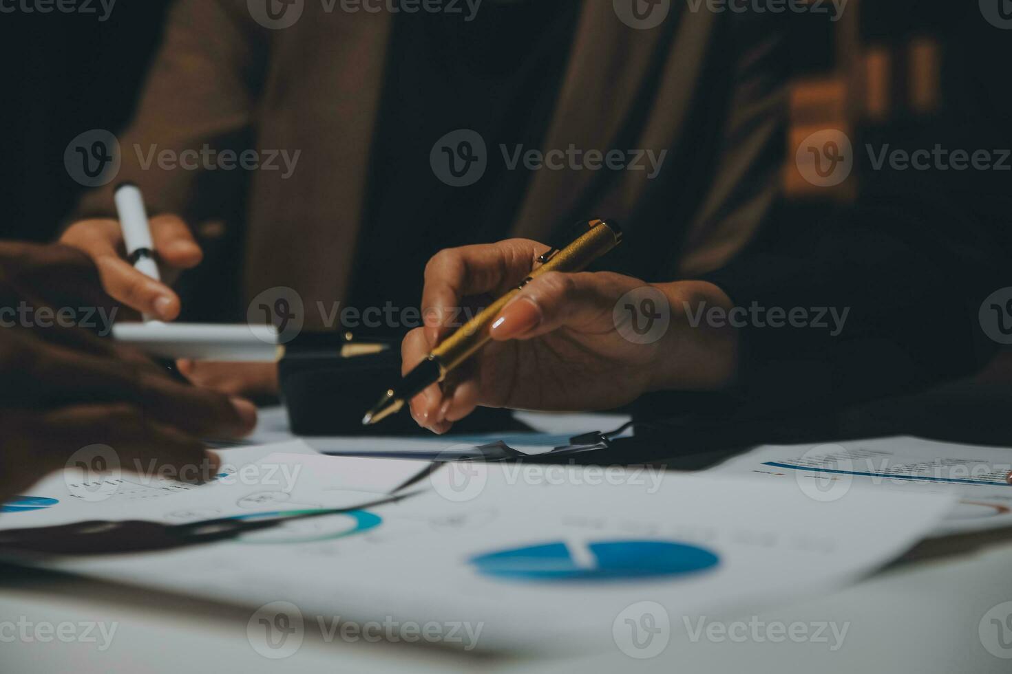 Financial analysts analyze business financial reports on a digital tablet planning investment project during a discussion at a meeting of corporate showing the results of their successful teamwork. photo