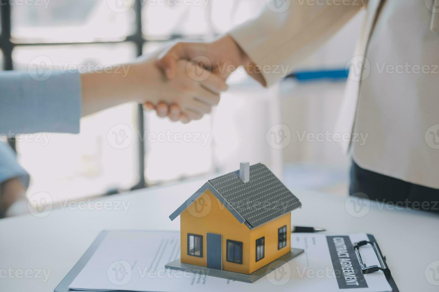 Real estate agent and customer signing contract to buy house, insurance or loan real estate.rent a house,get insurance or loan real estate or property. photo