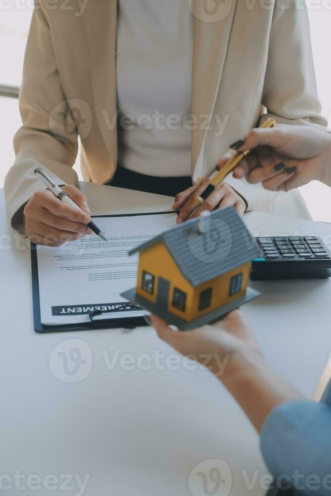 Real estate agent and customer signing contract to buy house, insurance or loan real estate.rent a house,get insurance or loan real estate or property. photo