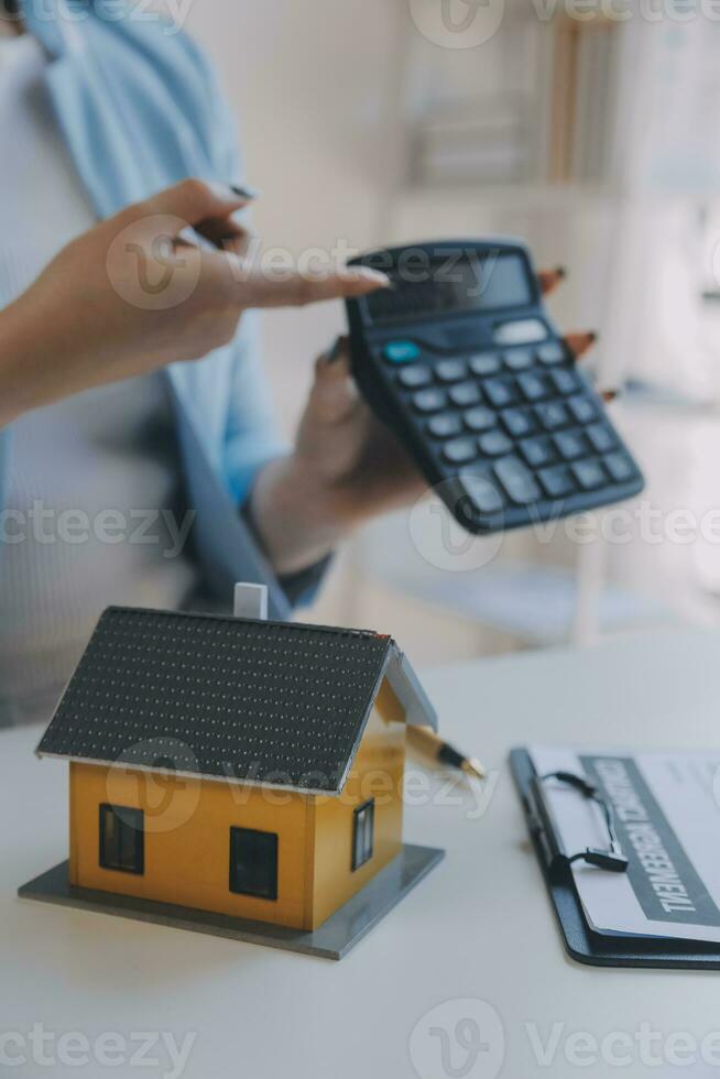 Real estate agent and customer signing contract to buy house, insurance or loan real estate.rent a house,get insurance or loan real estate or property. photo