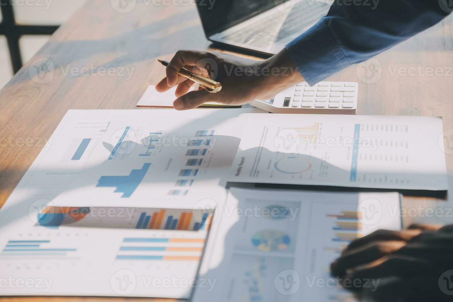 Close up of Business team analyzing income charts and graphs with modern laptop computer. Business analysis and strategy concept. photo