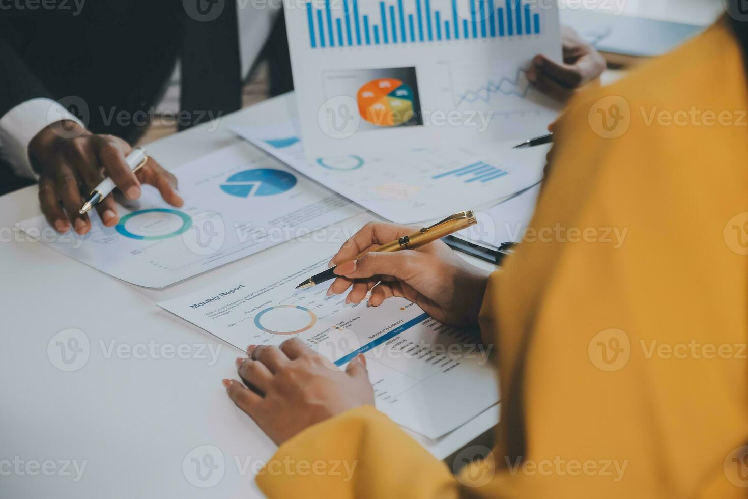 Financial analysts analyze business financial reports on a digital tablet planning investment project during a discussion at a meeting of corporate showing the results of their successful teamwork. photo