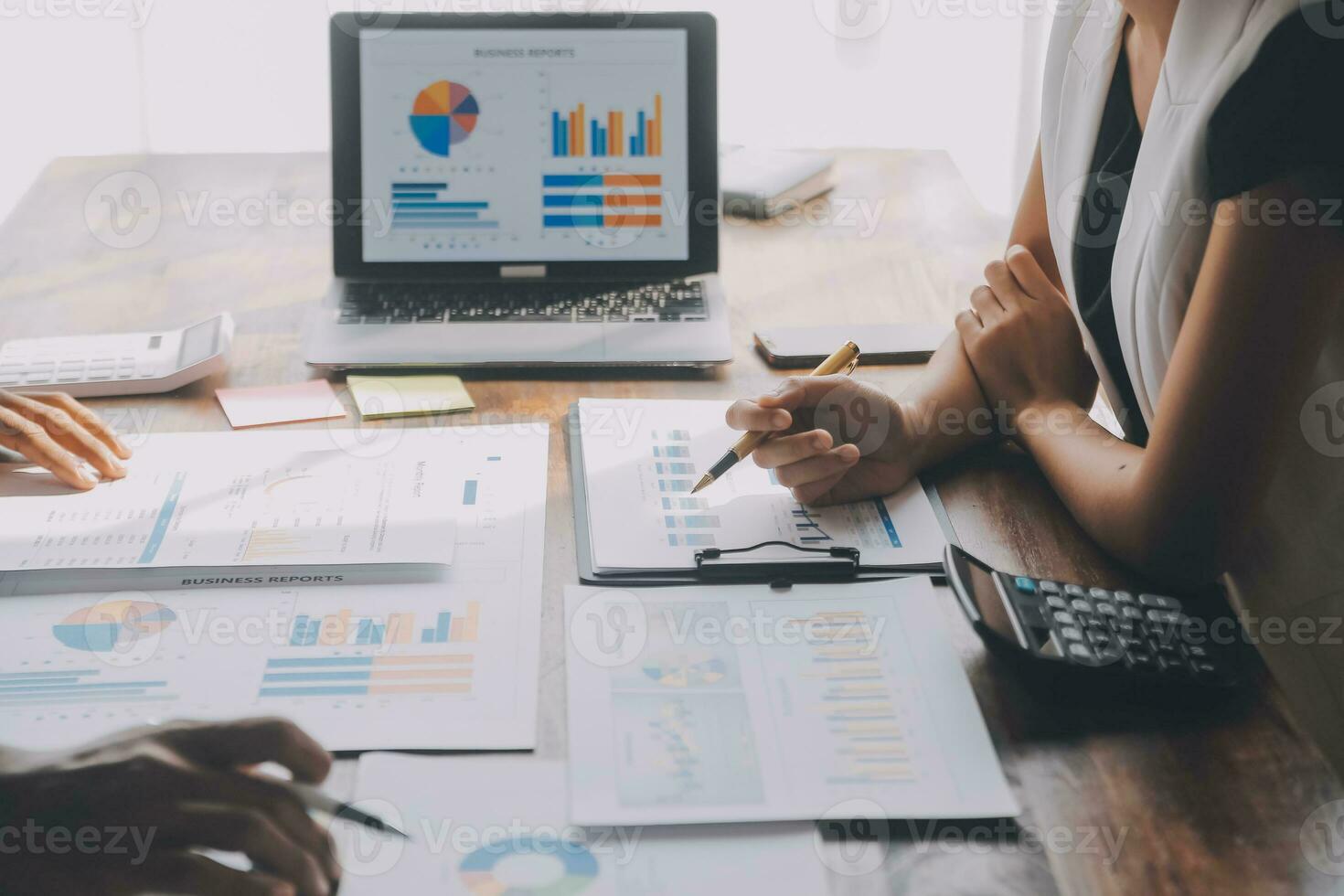 Close up of Business team analyzing income charts and graphs with modern laptop computer. Business analysis and strategy concept. photo