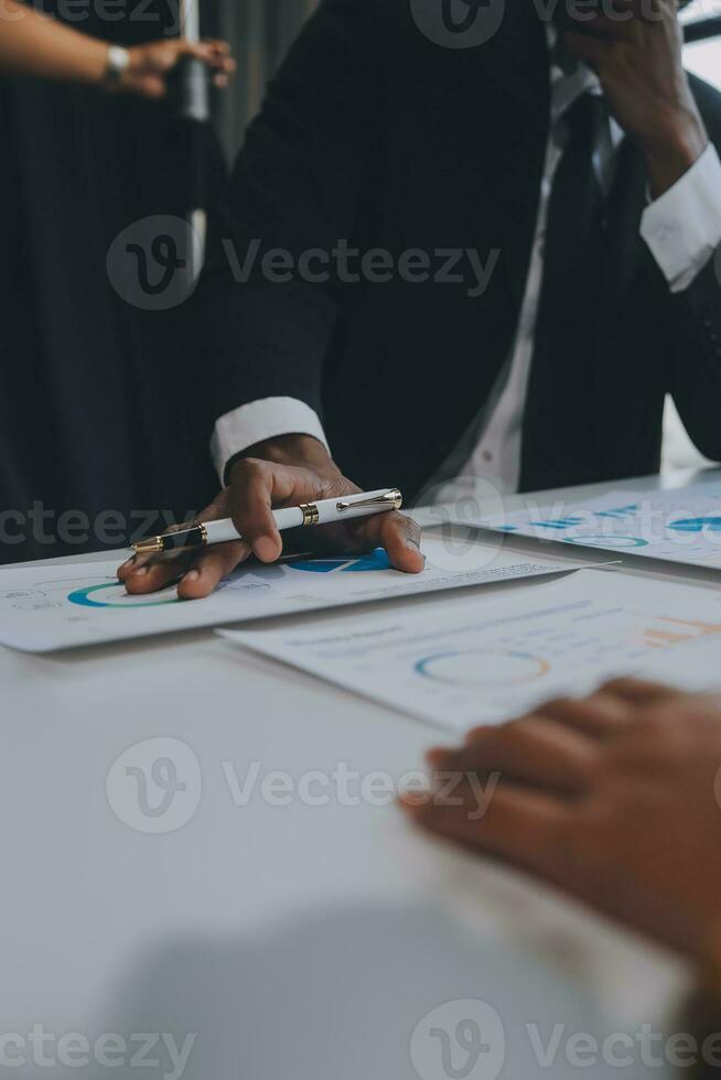 Financial analysts analyze business financial reports on a digital tablet planning investment project during a discussion at a meeting of corporate showing the results of their successful teamwork. photo