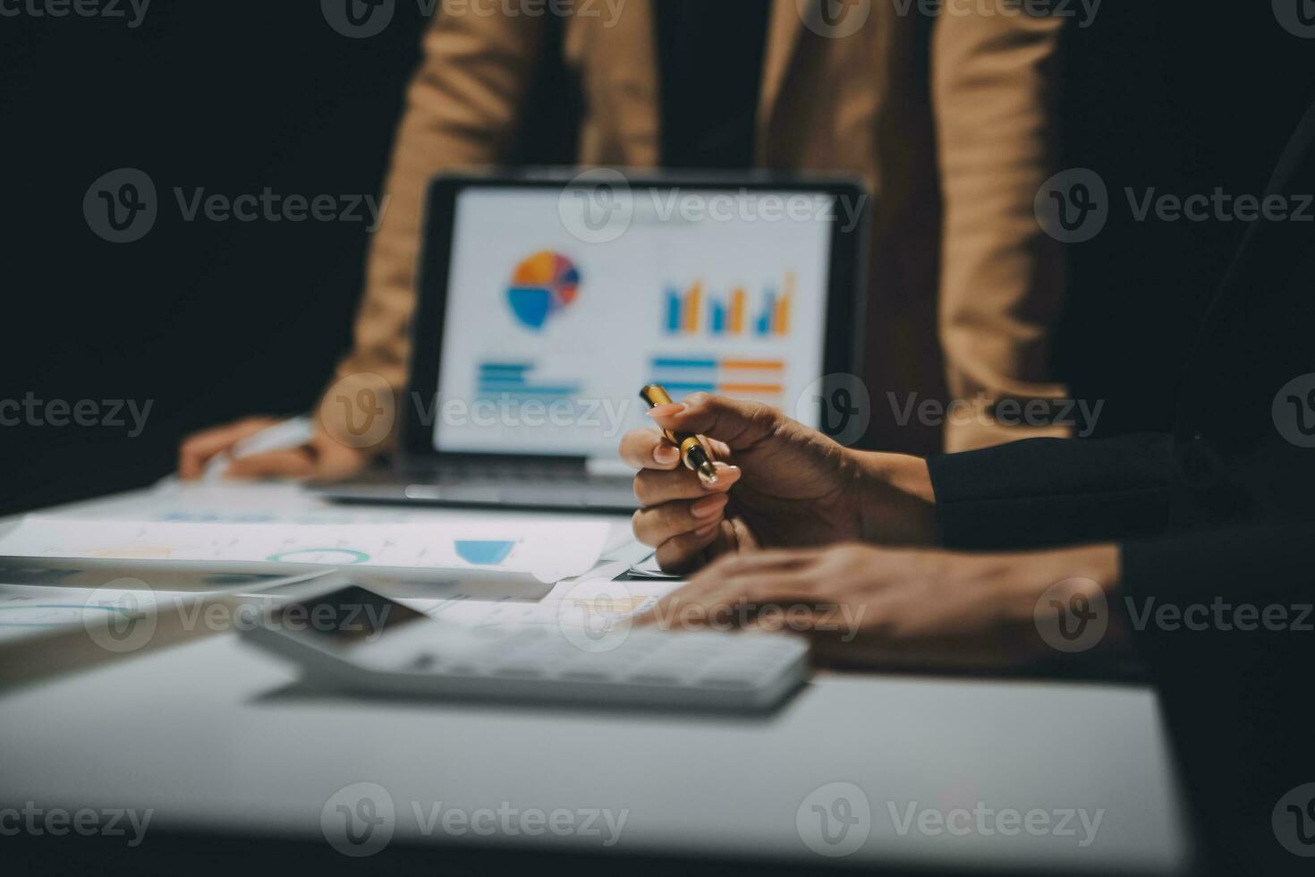 Financial analysts analyze business financial reports on a digital tablet planning investment project during a discussion at a meeting of corporate showing the results of their successful teamwork. photo