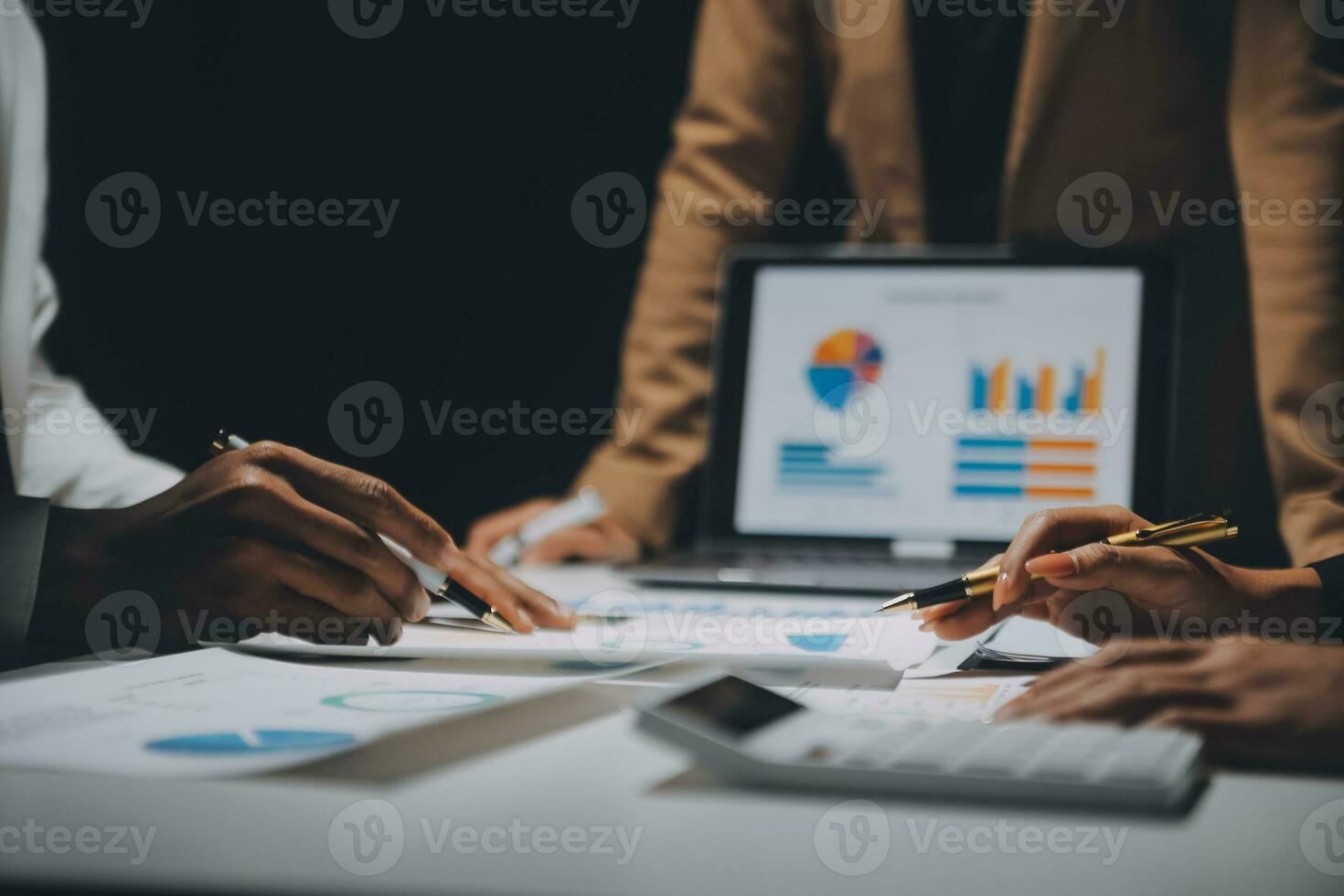 Financial analysts analyze business financial reports on a digital tablet planning investment project during a discussion at a meeting of corporate showing the results of their successful teamwork. photo
