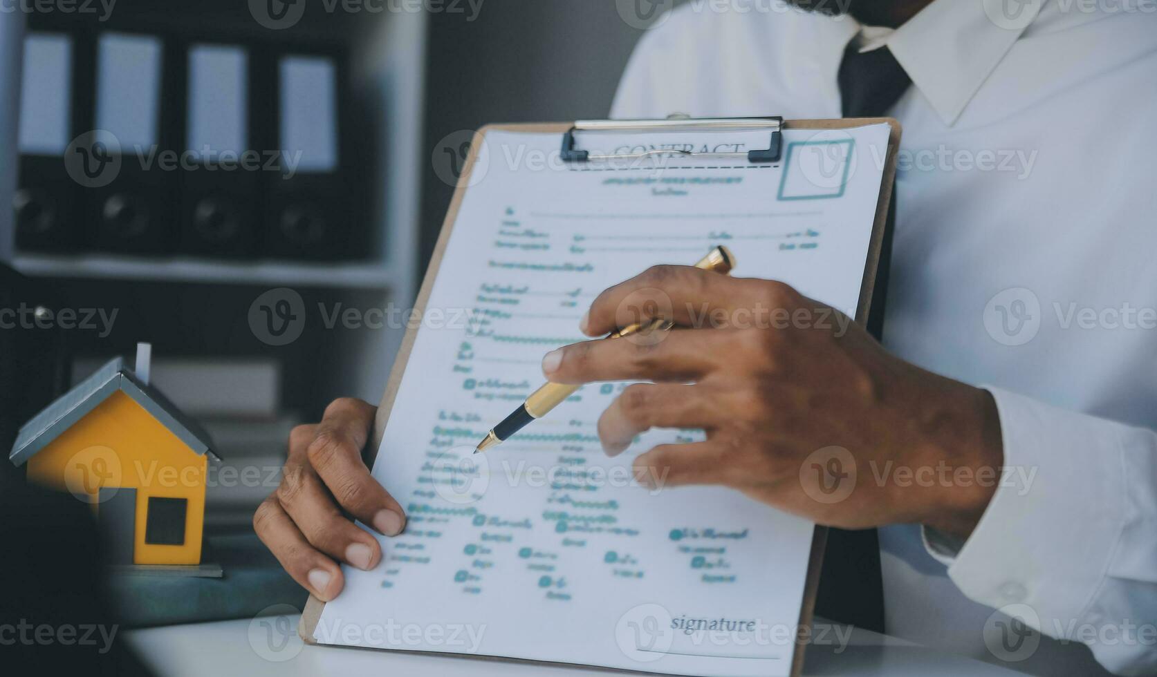 Real estate agent and customer signing contract to buy house, insurance or loan real estate.rent a house,get insurance or loan real estate or property. photo
