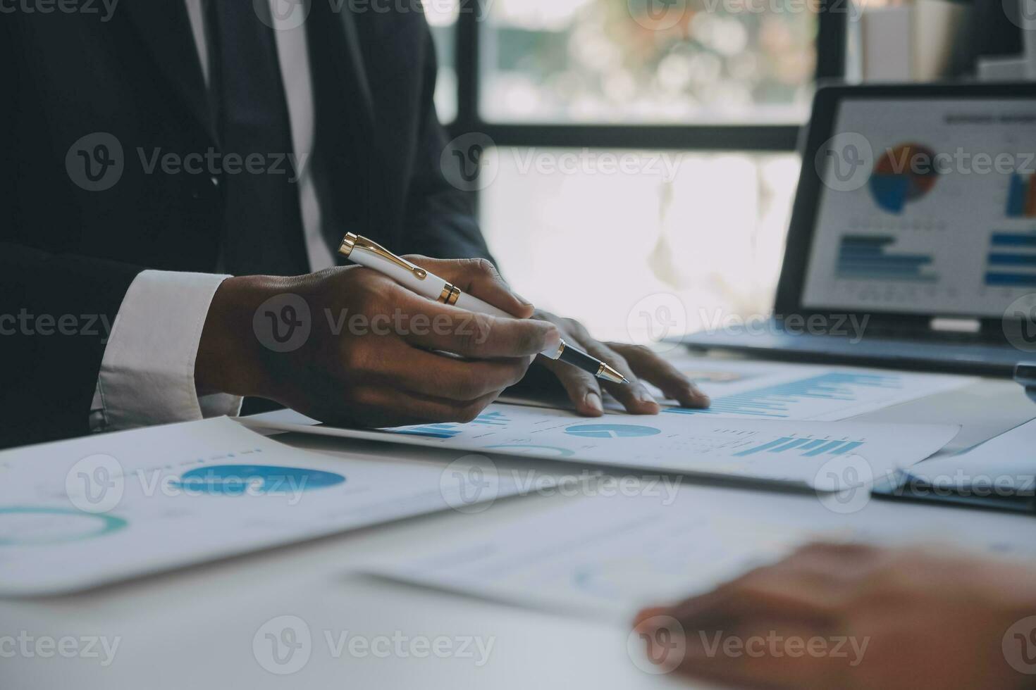 Financial analysts analyze business financial reports on a digital tablet planning investment project during a discussion at a meeting of corporate showing the results of their successful teamwork. photo