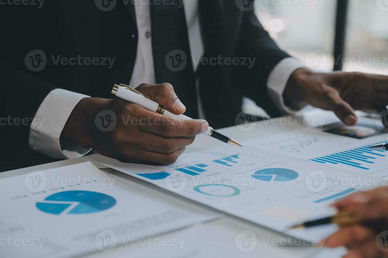 Financial analysts analyze business financial reports on a digital tablet planning investment project during a discussion at a meeting of corporate showing the results of their successful teamwork. photo