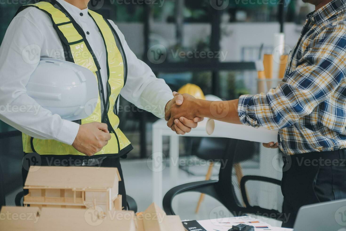 Construction and structure concept of Engineer or architect meeting for project working with partner and engineering tools on model building and blueprint in working site, contract for both companies. photo