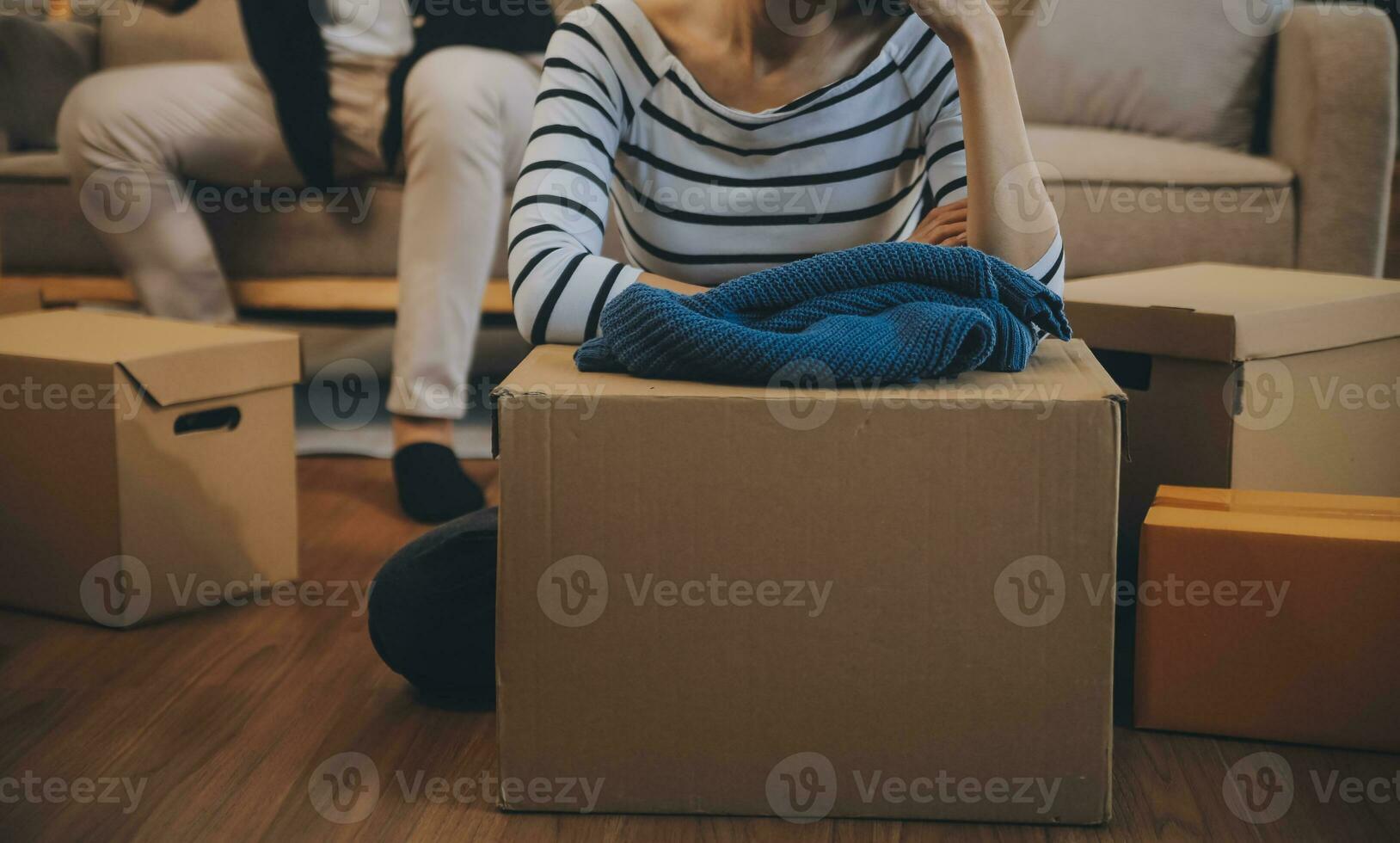 Two Asian blogger showing clothes in front of the camera to recording vlog video live streaming at her shop. Online Shopping Cart notion. on sofa at home photo
