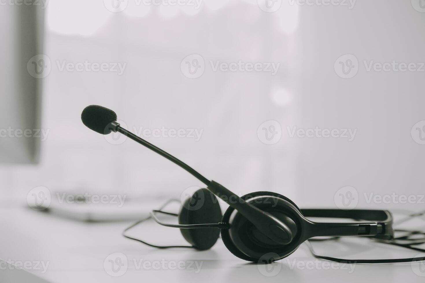 Communication support, call center and customer service help desk. VOIP headset on telephone keyboard. photo