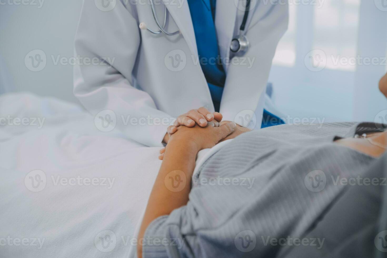 Doctor taking care, help and encourage Asian elder senior woman patient in clinic hospital. photo