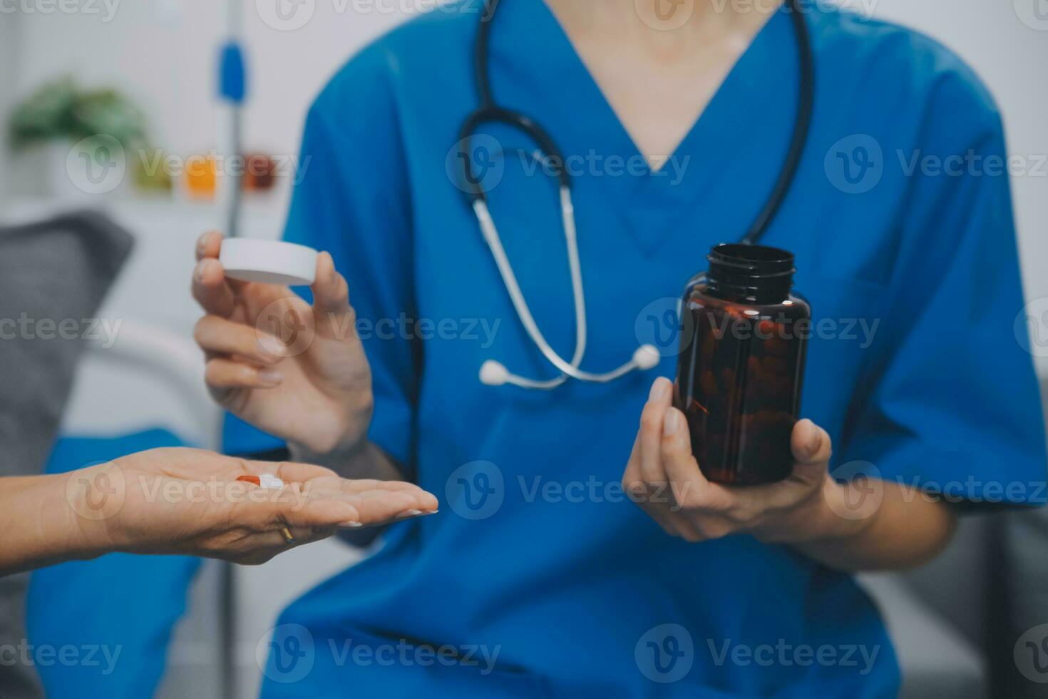 Asian woman nurse holding a medicine bottle and telling information to Asian senior woman before administering medication. Caregiver visit at home. Home health care and nursing home concept. photo
