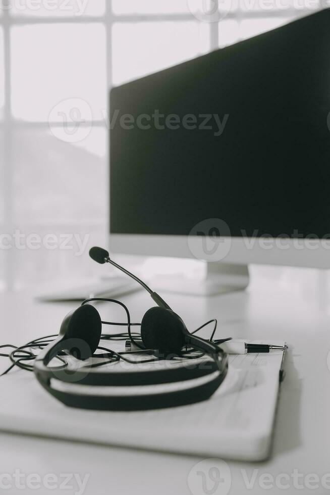 Communication support, call center and customer service help desk. VOIP headset on telephone keyboard. photo