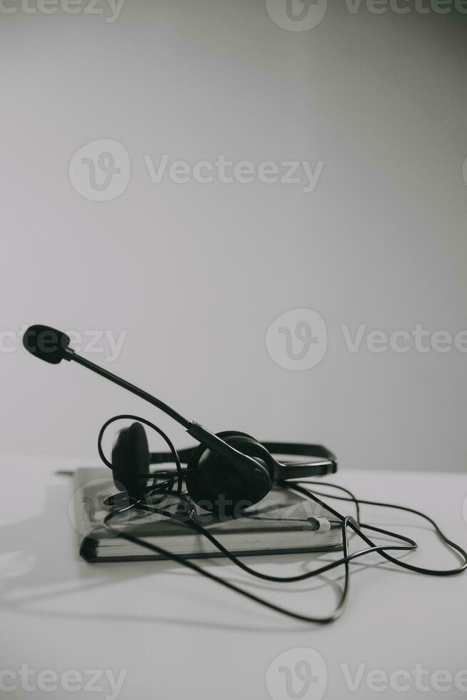 Communication support, call center and customer service help desk. VOIP headset on telephone keyboard. photo