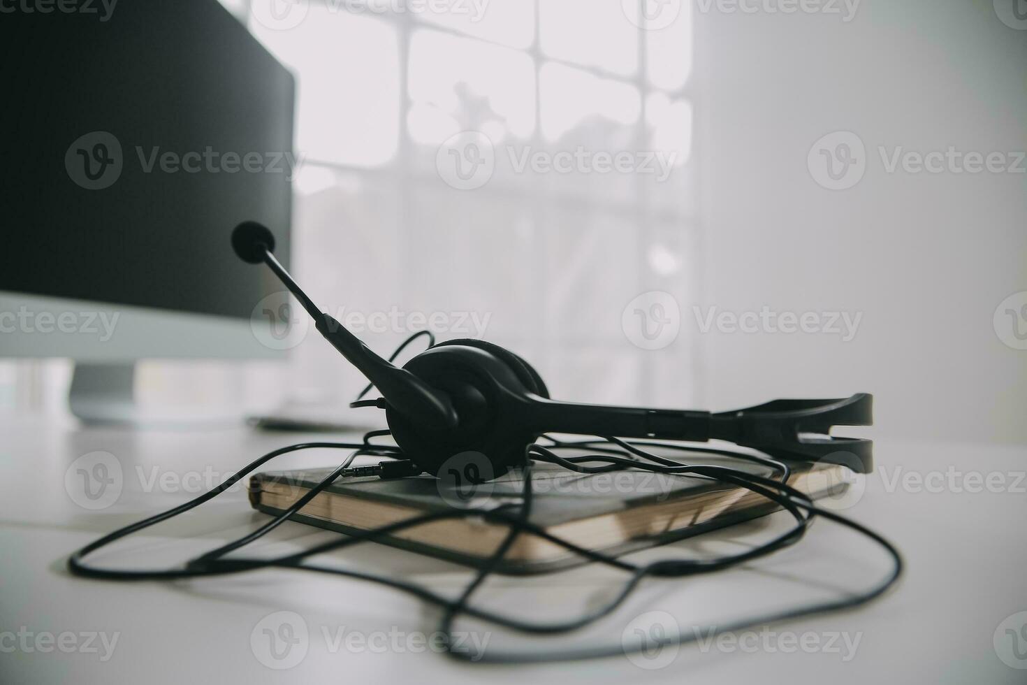 Communication support, call center and customer service help desk. VOIP headset on telephone keyboard. photo