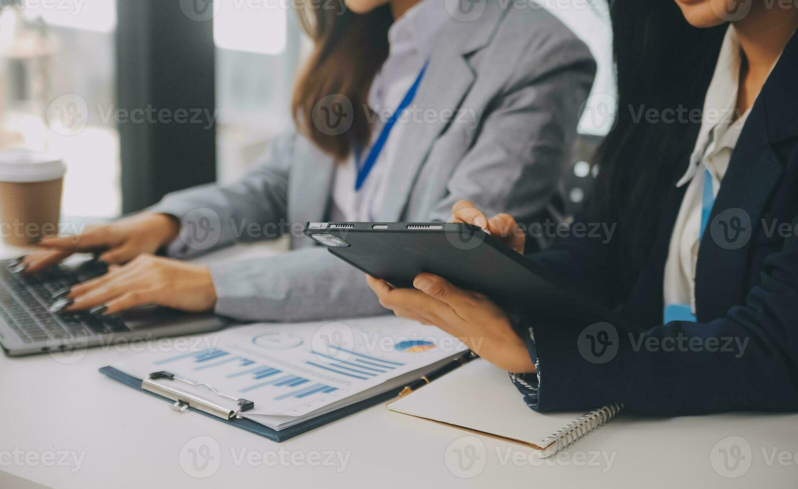 Business team two colleagues discussing new plan financial graph data on office table with laptop and digital tablet. photo
