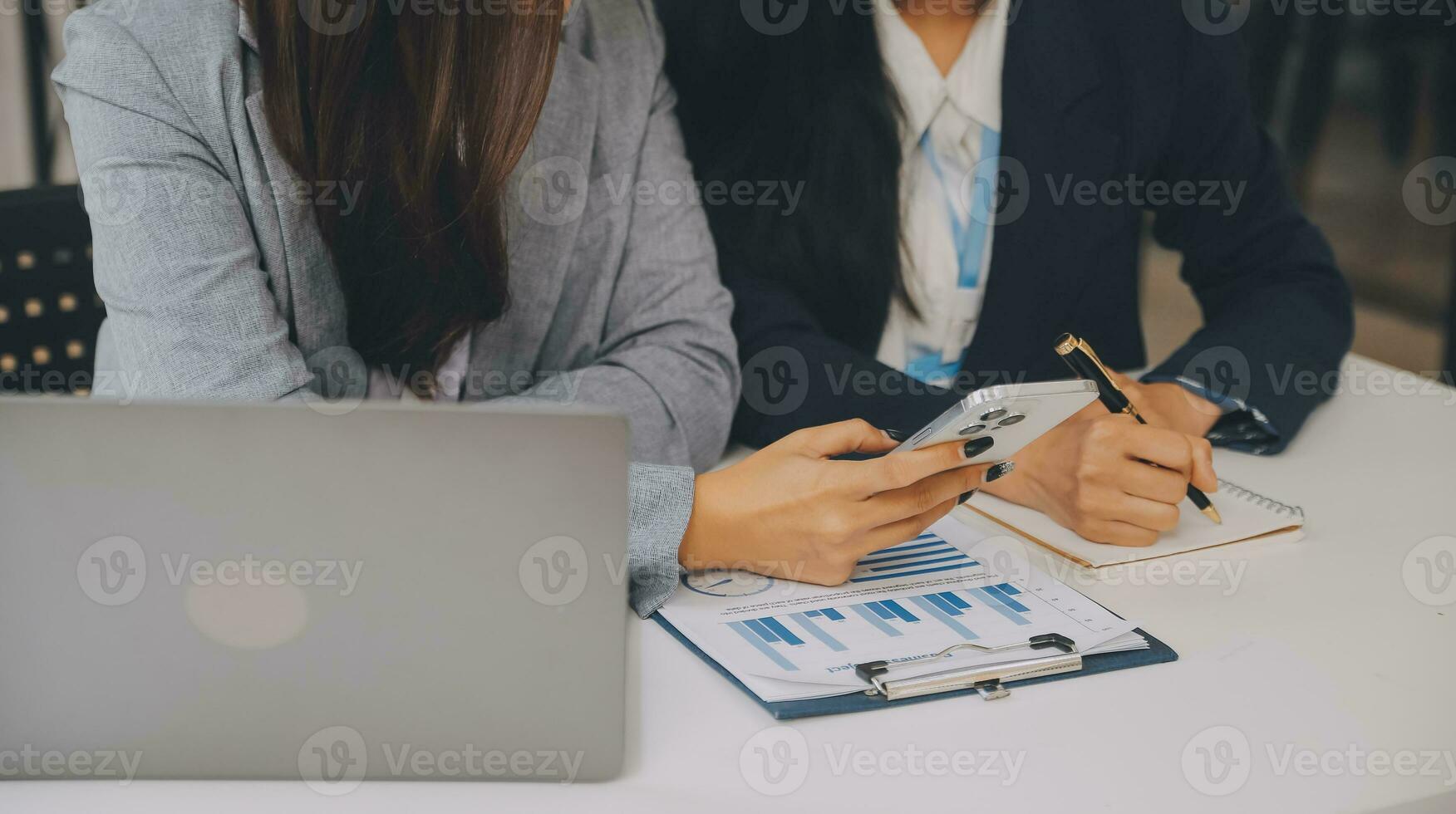 Business team two colleagues discussing new plan financial graph data on office table with laptop and digital tablet. photo