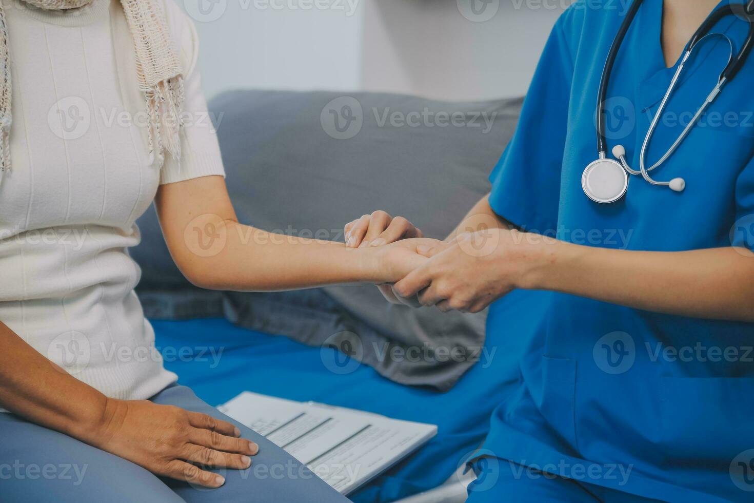 Young asian caretaker with 60s asia elderly woman consulting and encourage, take a history and recommend the right treatment, holding hands and encouraging photo