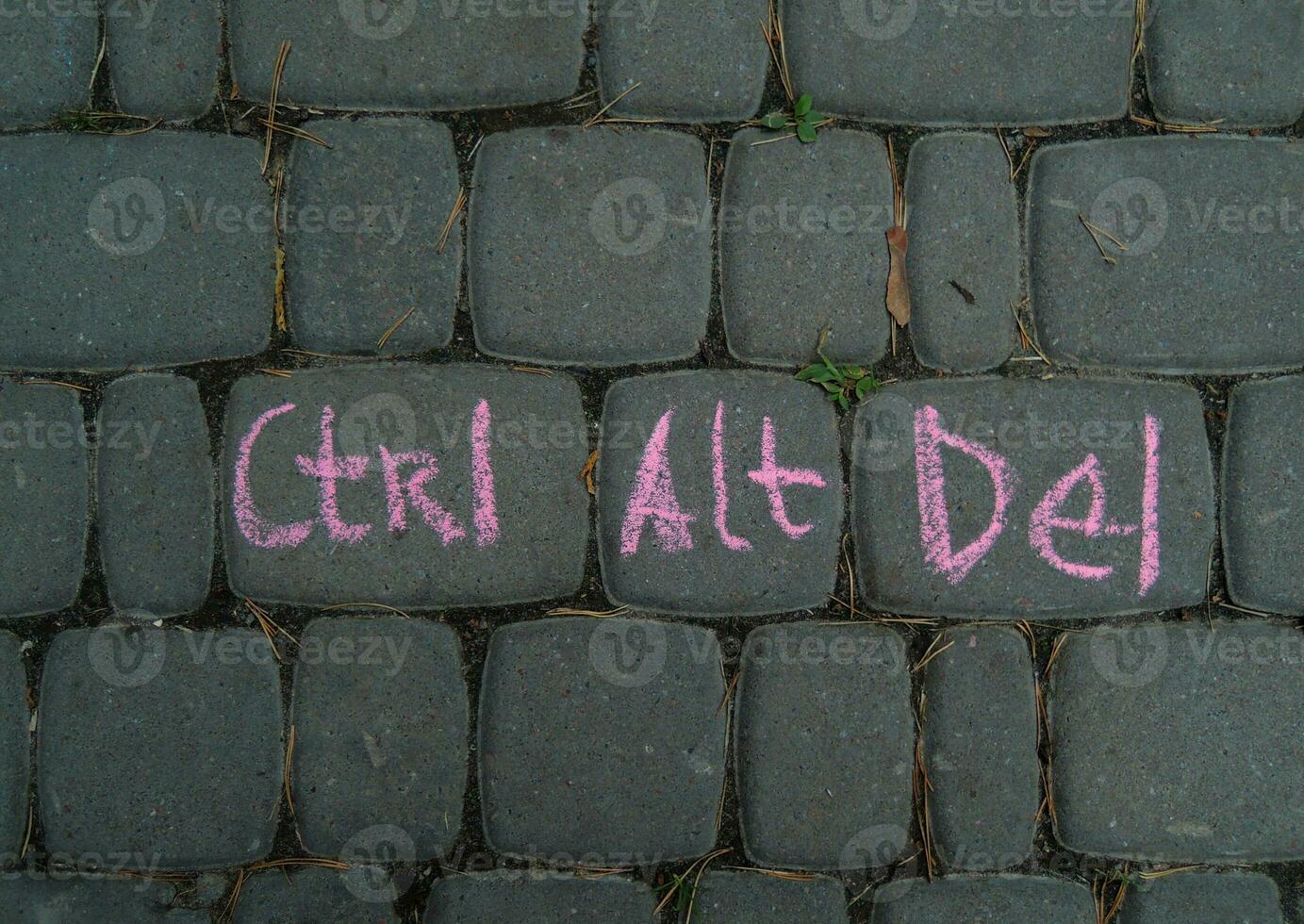 Contral, Alt, Delete Words Combination Written By Red Chalk On A Gray Paving Like On A Computer Keyboard photo
