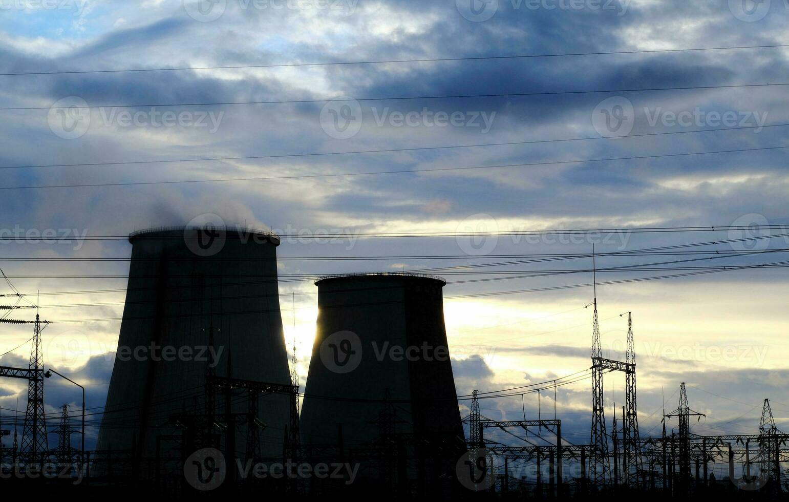 High voltage power lines and cooling towers of giant power station photo