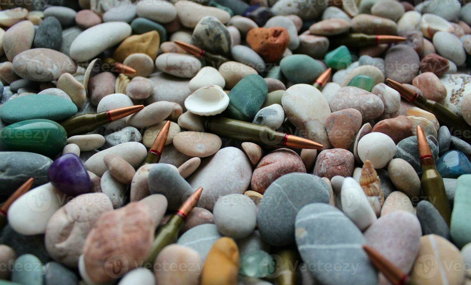 Bullets are sprinkled with small pebbles and seashells angle view stock photo
