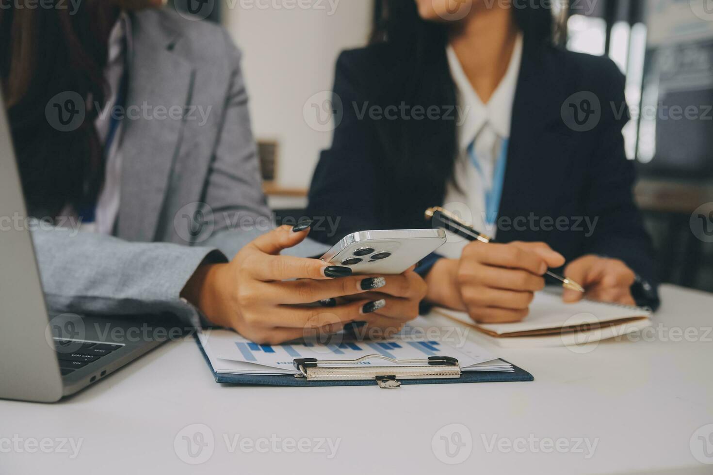 Business team two colleagues discussing new plan financial graph data on office table with laptop and digital tablet. photo