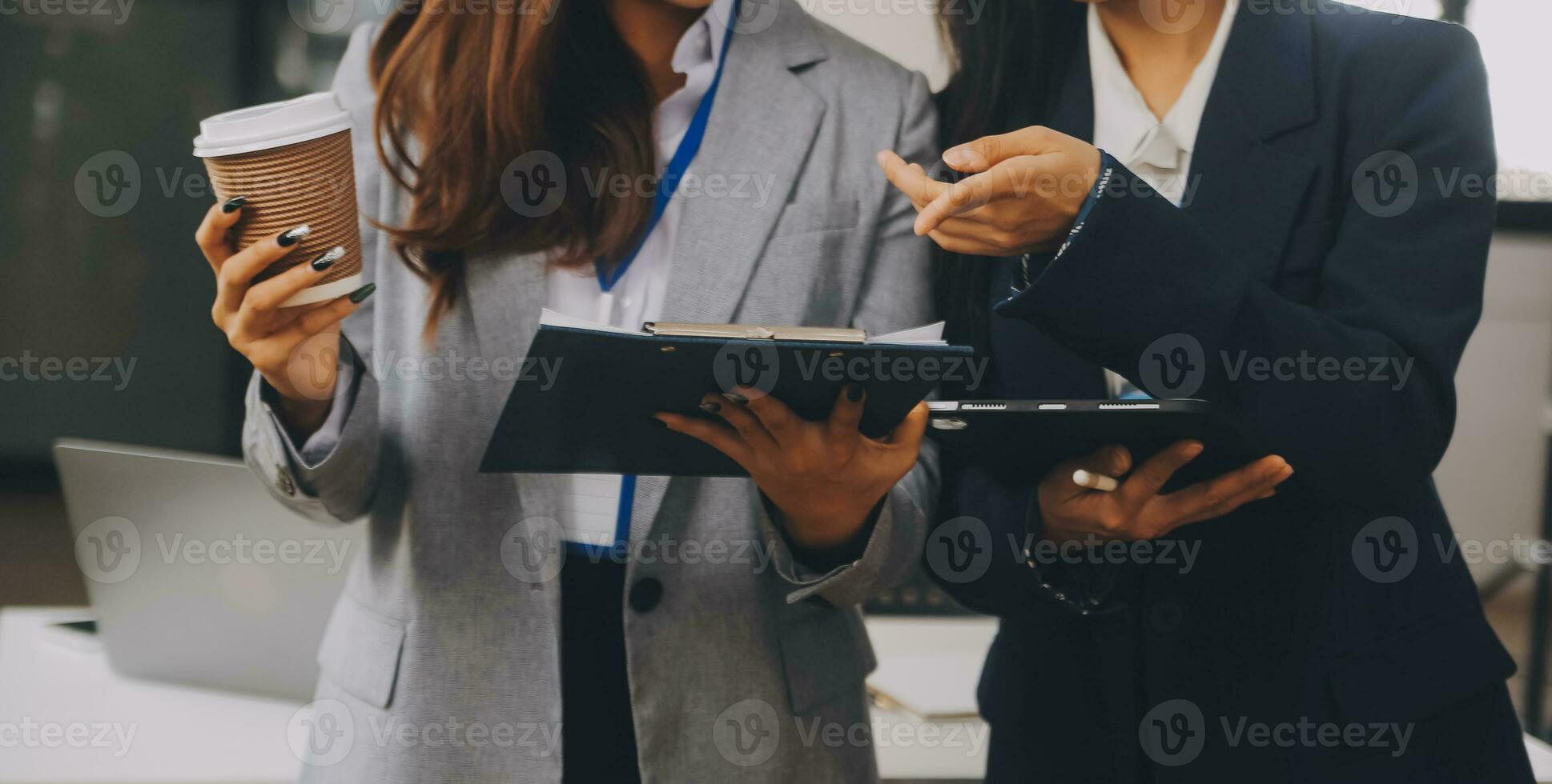 Business team two colleagues discussing new plan financial graph data on office table with laptop and digital tablet. photo