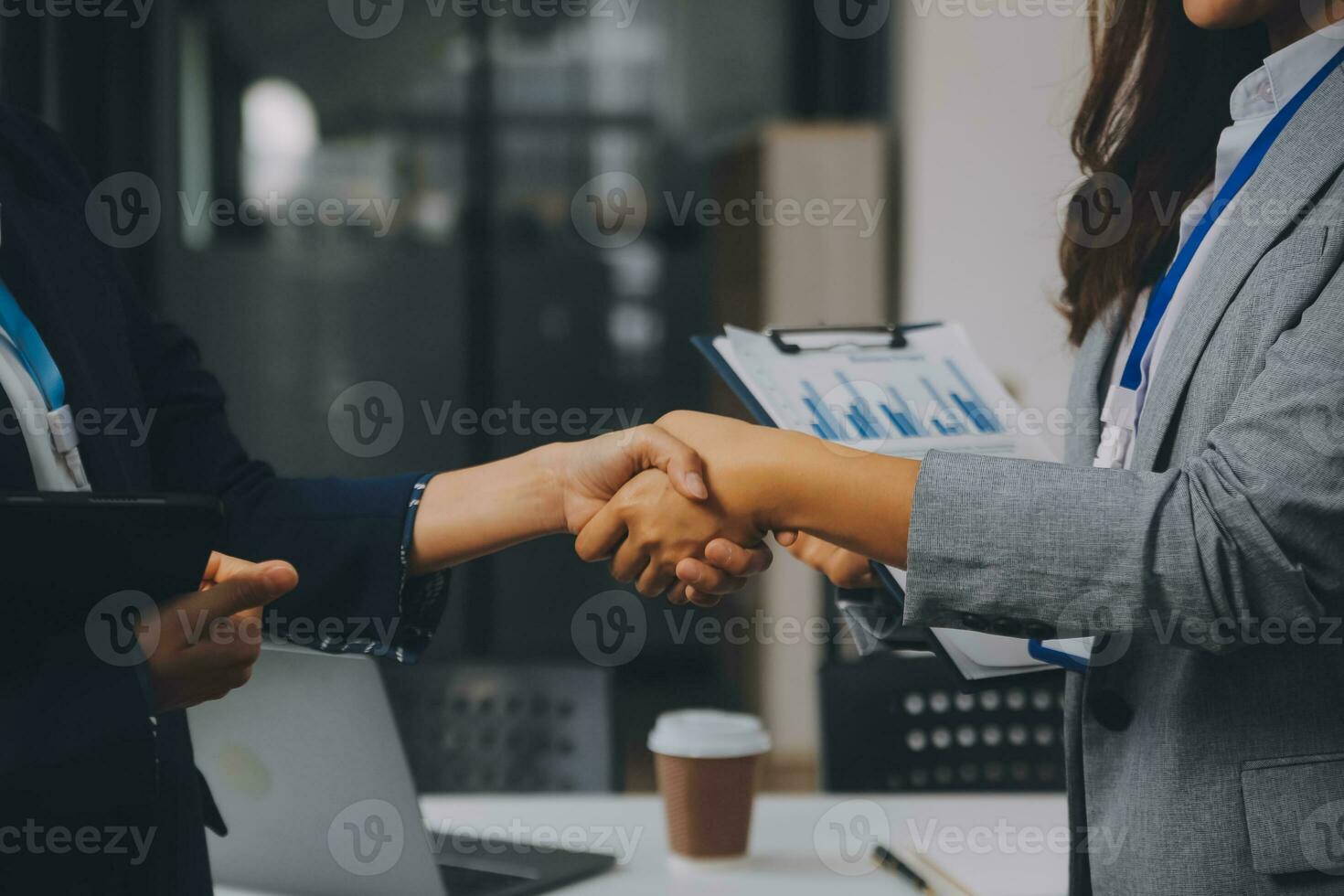 Real estate broker agent and customer shaking hands after signing contract documents for realty purchase, Bank employees congratulate, Concept mortgage loan approval. photo