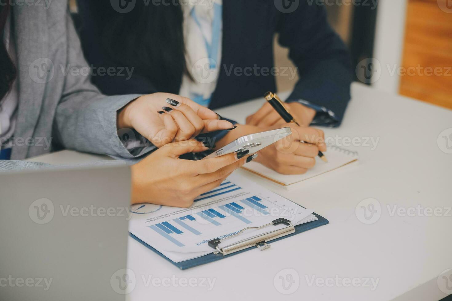 Business team two colleagues discussing new plan financial graph data on office table with laptop and digital tablet. photo