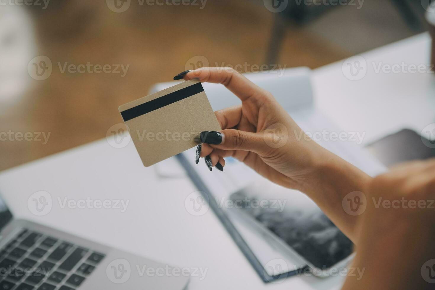 Women holding credit card and using smartphones at home.Online shopping, internet banking, store online, payment, spending money, e-commerce payment at the store, credit card, concept photo