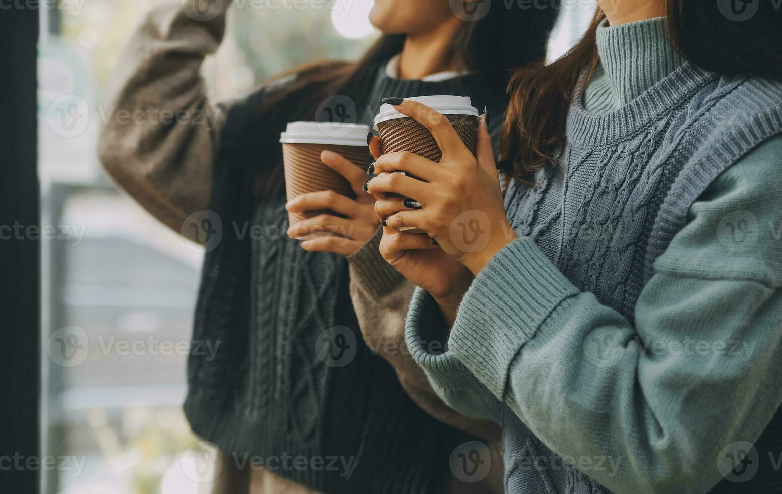 Happy colleagues having a coffee break in an office. Group of business people having a conversation in a workplace. Business professionals working in a startup. photo
