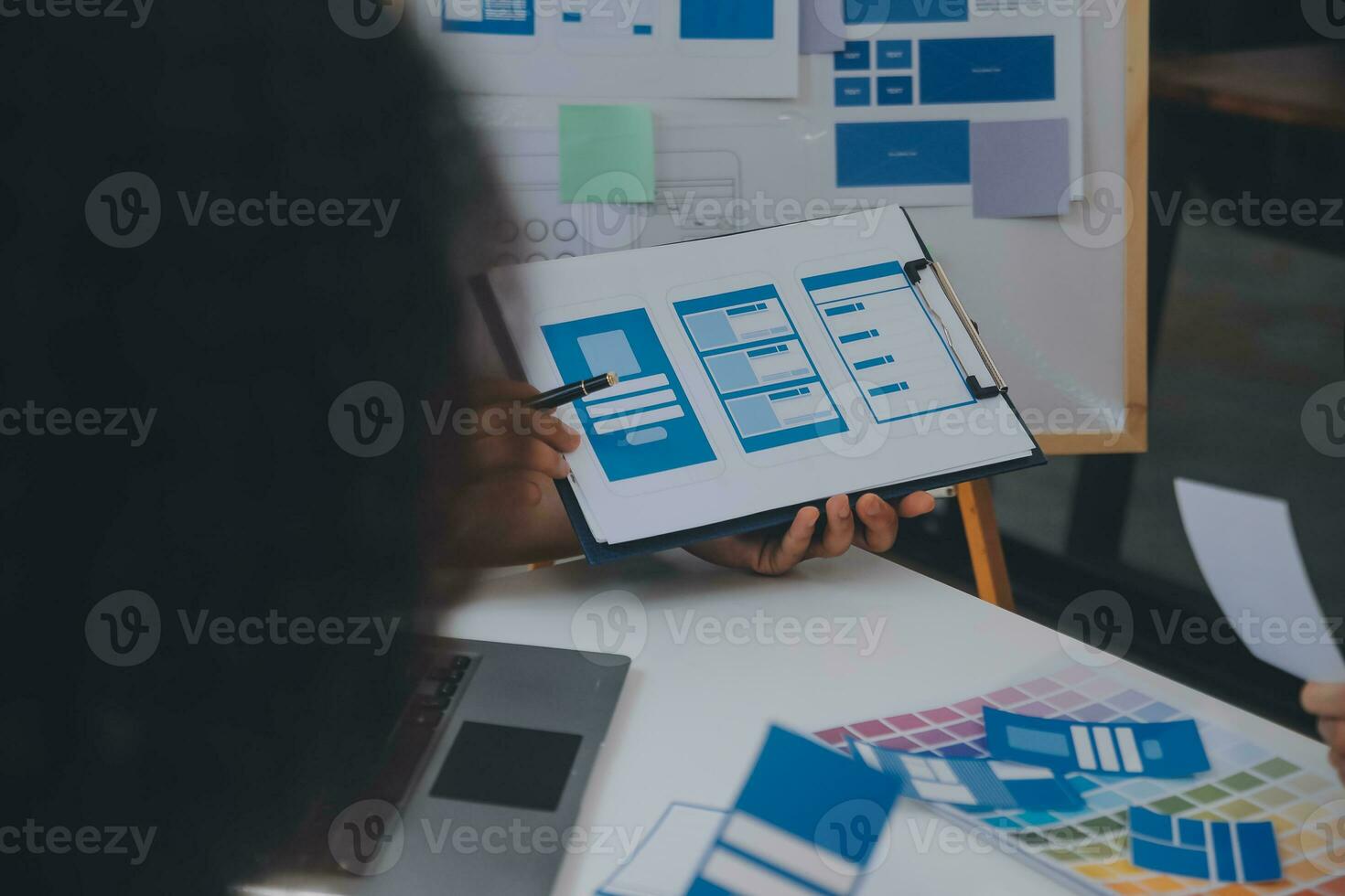 Close up ux developer and ui designer use augmented reality brainstorming about mobile app interface wireframe design on desk at modern office.Creative digital development agency photo