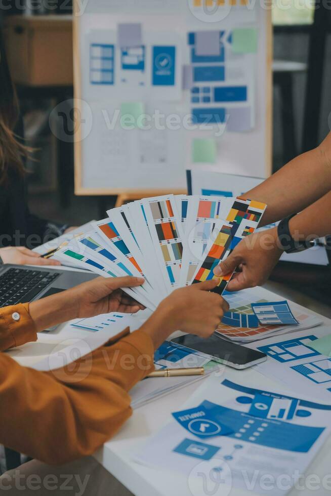 Close up ux developer and ui designer use augmented reality brainstorming about mobile app interface wireframe design on desk at modern office.Creative digital development agency photo