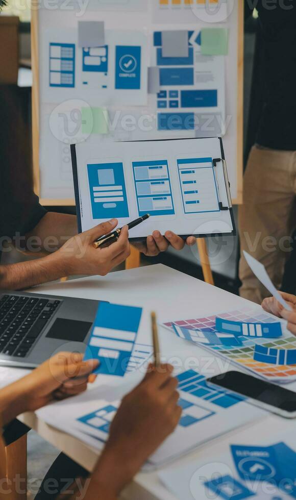 Close up ux developer and ui designer use augmented reality brainstorming about mobile app interface wireframe design on desk at modern office.Creative digital development agency photo