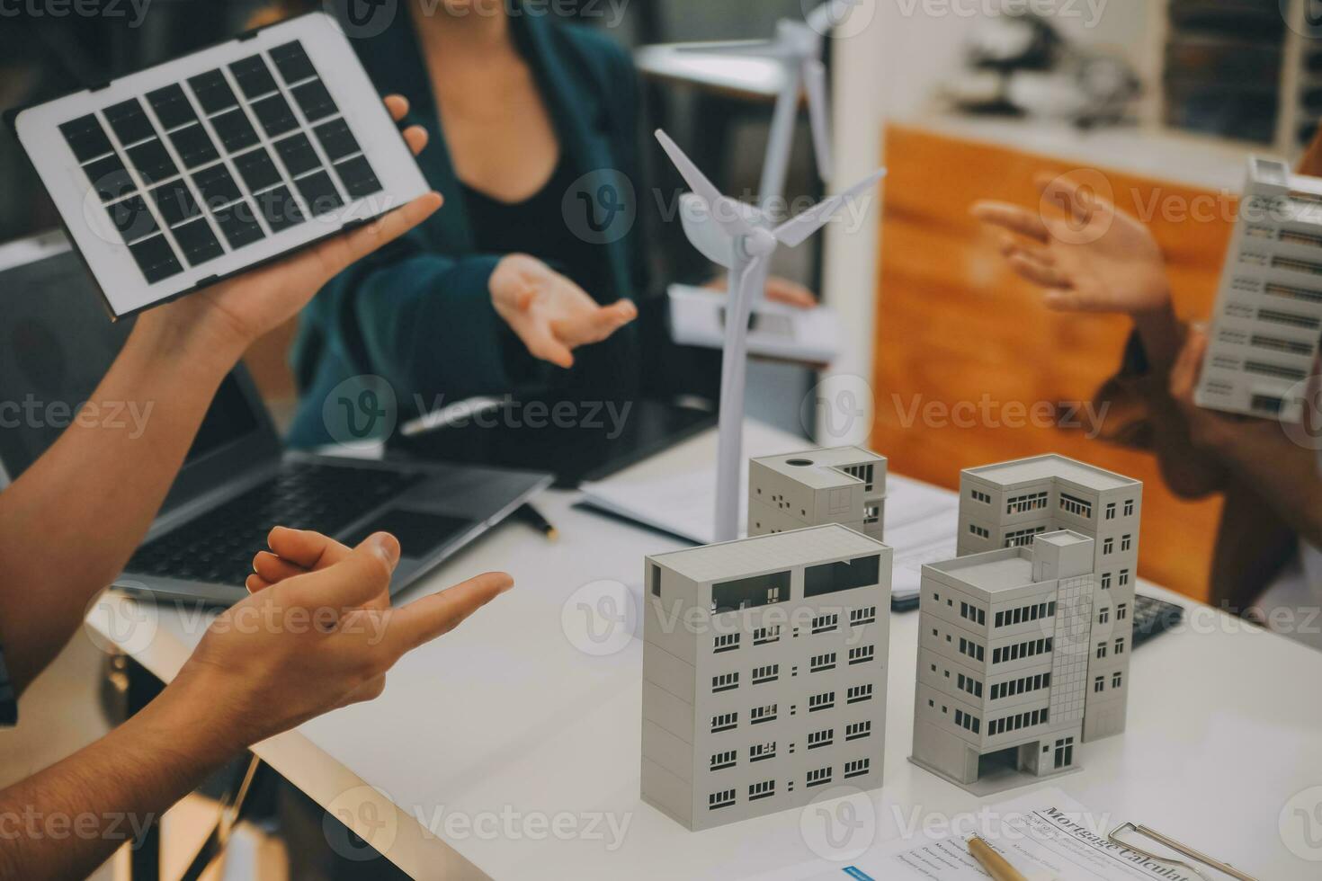 Electrical engineer with businessman discussing new project installation solar cell panel on the roof of building. Alternative energy concept. photo