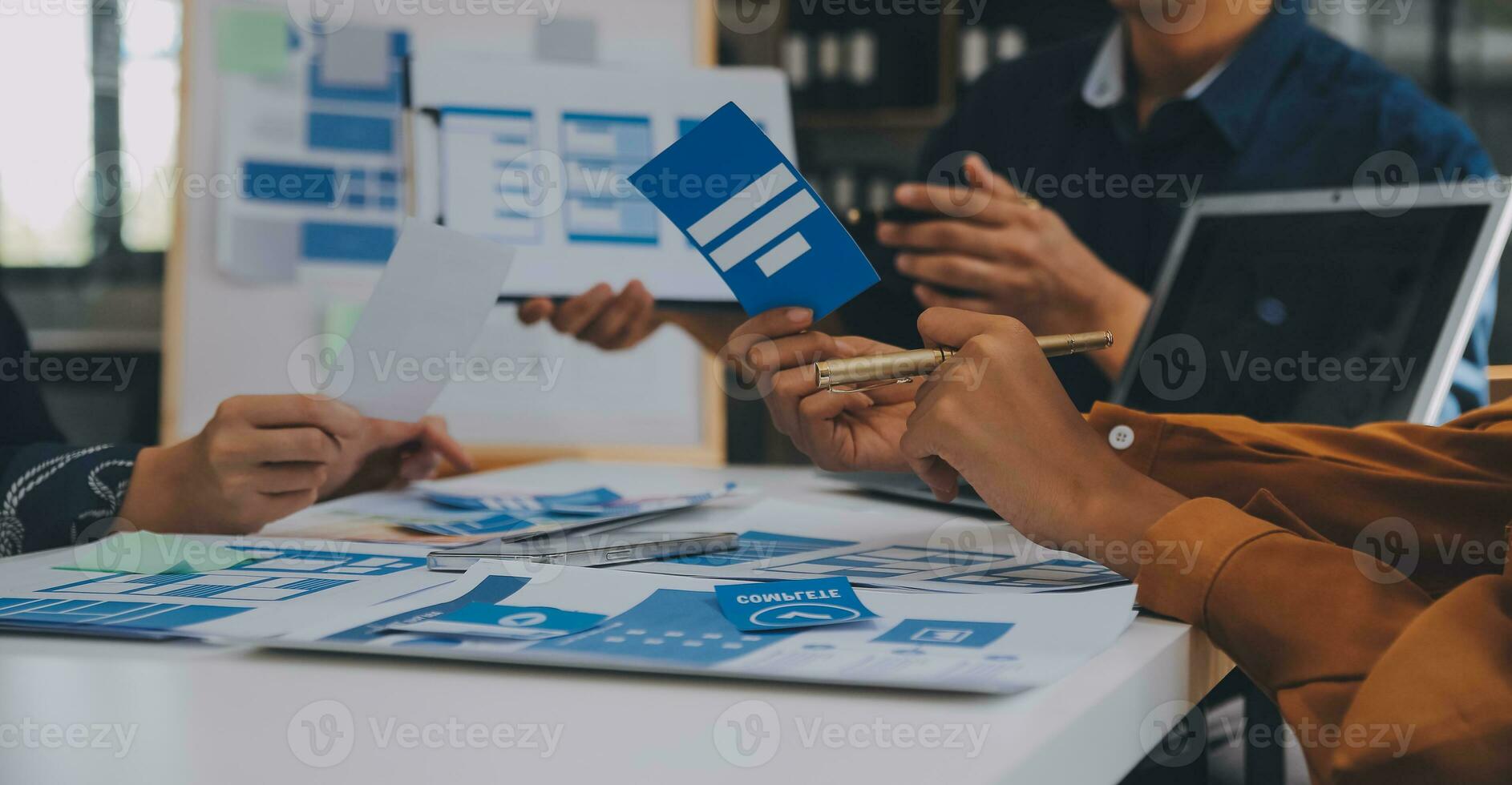 Close up ux developer and ui designer use augmented reality brainstorming about mobile app interface wireframe design on desk at modern office.Creative digital development agency photo